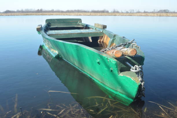 istock Rowing boat moored to the shore. Spring on the river. Floating. 1077312660