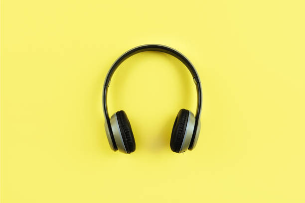 istock headphones on yellow background. 1077312876