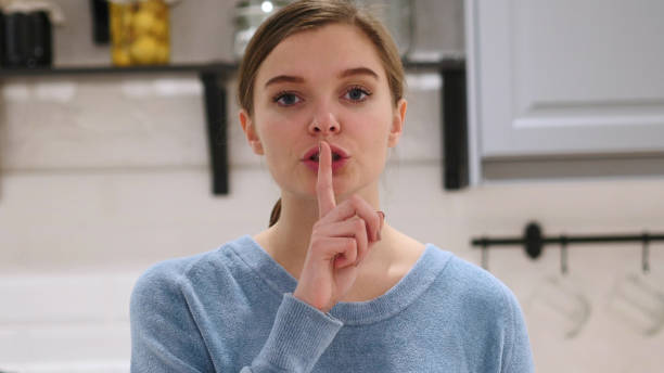istock Finger on Lips, Woman Asking for Silence 1077313270