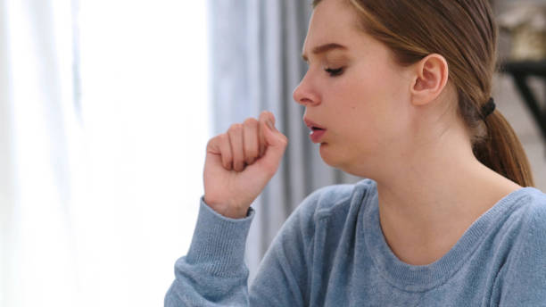 istock Sick Woman Coughing, Sitting at Home 1077313514