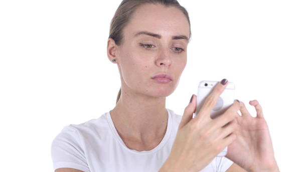 istock Middle Aged Woman at Work Browsing Smartphone in Office 1077315622