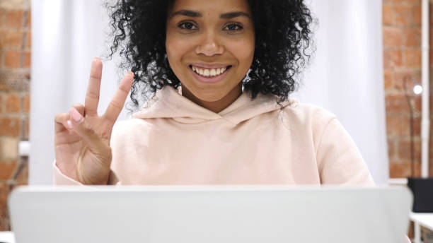 istock Victory Gesture by Young Afro-American Woman 1077318616