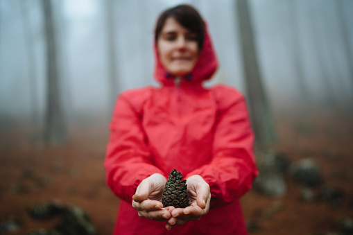 Woman holding pine cone