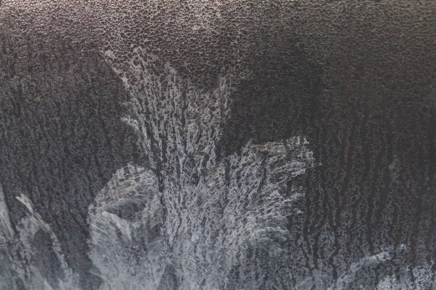 istock Painted developed frosty patterns on the winter ice window 1077329060