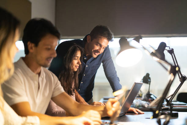 istock Businessman leading team at late working 1077330924