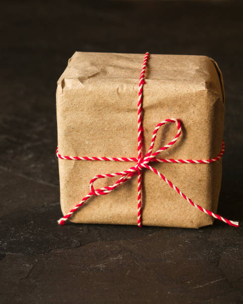 istock Gift Box, Ribbon - Kraft Paper  (dark background). top view, copy spac 1077331100