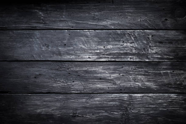 istock Black wood scratched desk board texture. Abstract background, empty template, text space. 1077336440