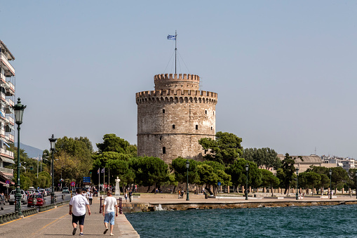 Thessaloniki, Greece - July 22, 2018: The White Tower of Thessaloniki on north shore of the Aegean Sea, Greece. The tower was built as a fortification by Ottoman Sultan Murad II.