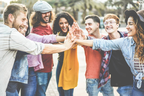 istock Young millennials friends stacking hands together - Happy students celebrating together - Youth lifestyle, university, social trends, relationship and friendship concept - Focus on hands 1077350186