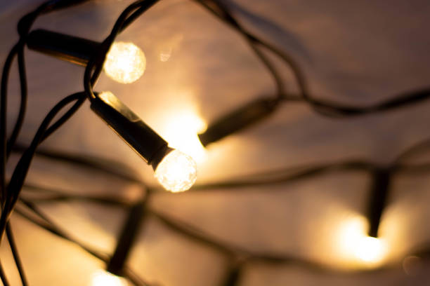 istock Christmas background with selective focus. Bokeh lights over wooden wihte rustic planks. 1077350786
