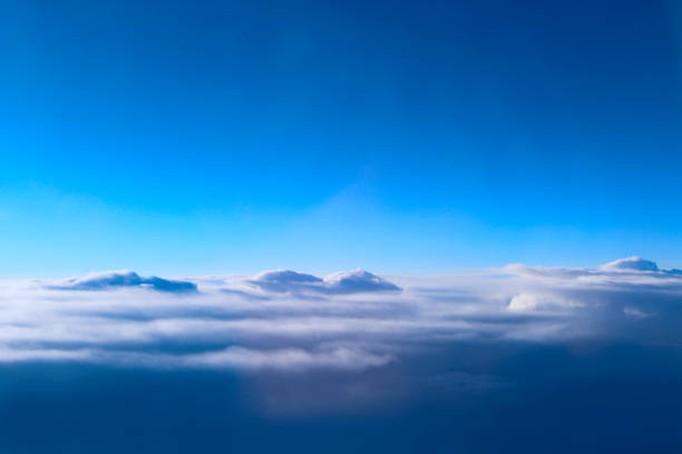 istock view from window of plane to white clouds 1077354596