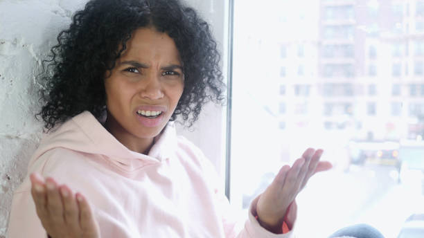istock Young African Woman Reacting to Failure and Problems, Sitting at Window 1077357672