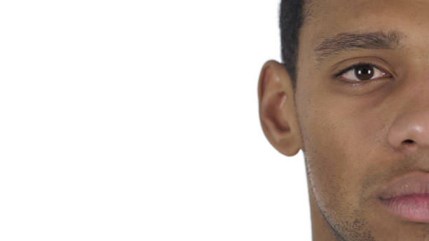 istock Half Face of Serious Man Looking at Camera, White Background 1077357904