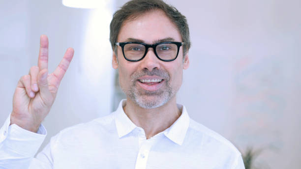 istock Victory Sign by Middle Aged Man 1077358720