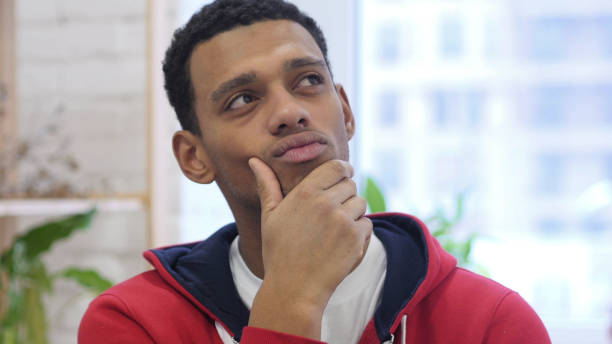 istock Portrait of Handsome Thinking Afro-American Man Gesturing  Brainstorming 1077359668