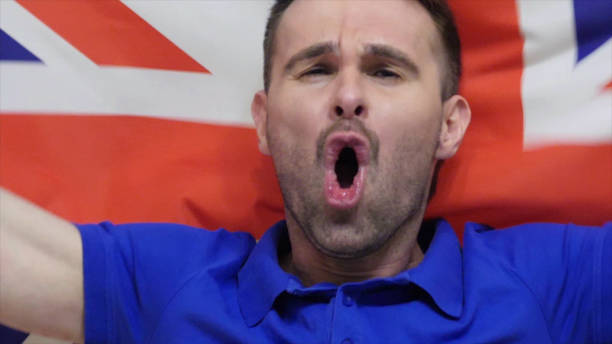 istock British Fan Celebrates holding the British Flag in Slow Motion 1077360162