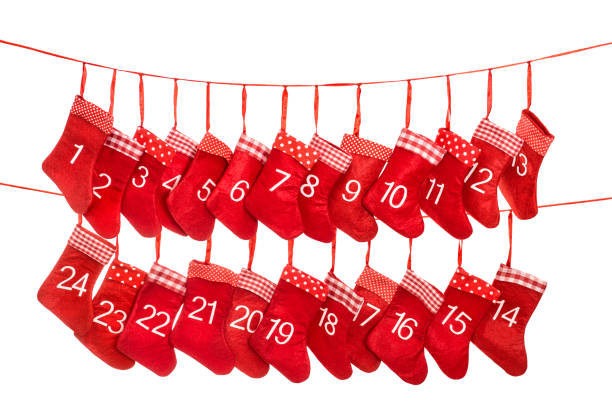 Woman making Christmas advent calendar. Pouches on a rope.
