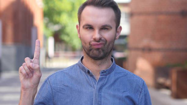 istock No, Casual Man Rejecting Offer by Waving Finger 1077360768