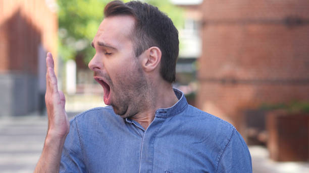 istock Yawning Tired Casual Man need Sleep 1077360882