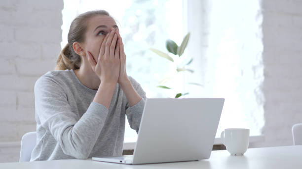 istock Young Woman in Shock Working on Laptop 1077361074