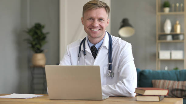 istock Smiling Positive Doctor At Work Looking at Camera 1077363308