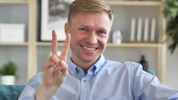 istock Victory Sign by Positive Businessman 1077363434