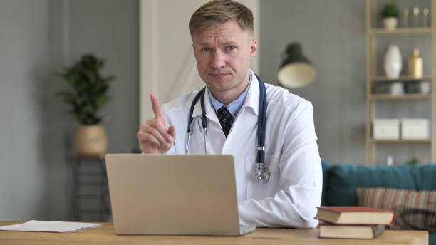 istock No, Rejecting Doctor Looking at Camera in Clinic 1077364530