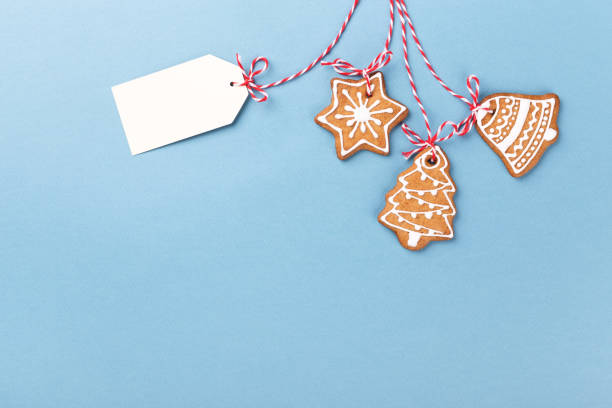 istock Gingerbread cookies hanging over blue background 1077367622
