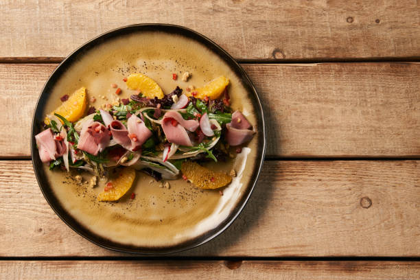 istock Smoked duck breast with fresh vegetable salad on wooden table ba 1077373922