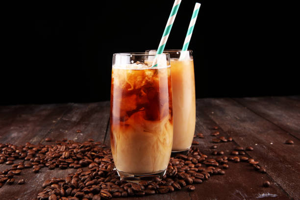 istock Ice coffee on a rustic table with cream being poured into it showing the texture and refreshing look of the drink 1077386808
