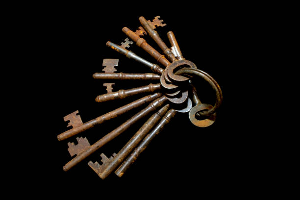 istock Rusty Old Antique Bunch of Keys on Black Background 1077388490