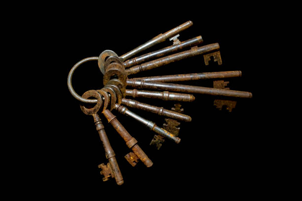 istock Rusty Old Antique Bunch of Keys on Black Background 1077388492