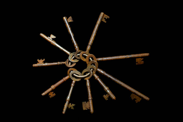 istock Rusty Old Antique Bunch of Keys on Black Background 1077388522