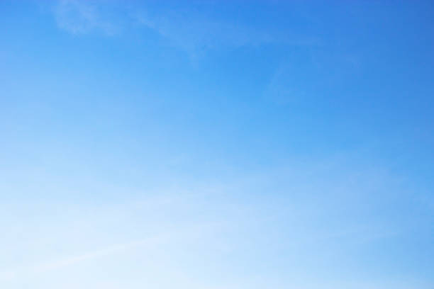 istock Fluffy blue sky background and white clouds soft focus, and copy space 1077397400