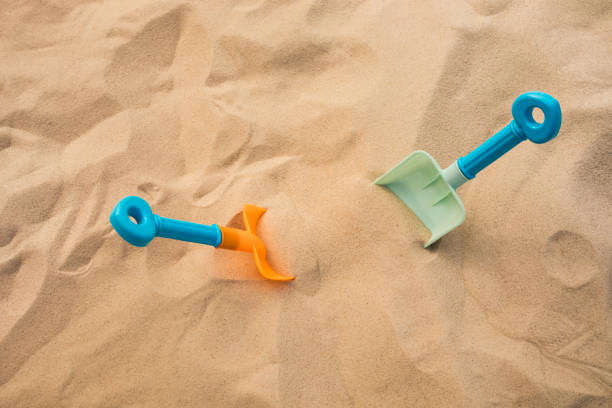 Shovel toy on sand,beach summer and vacation concepts Shovel toy on sand,beach summer and vacation concepts with kid sandbox stock pictures, royalty-free photos & images
