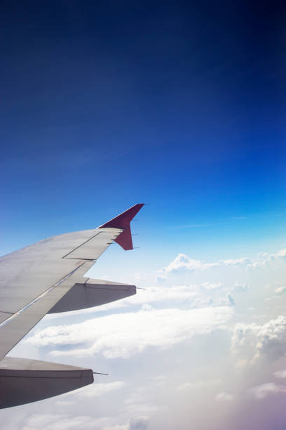 istock Blue sky and wing of airplane. 1077399170