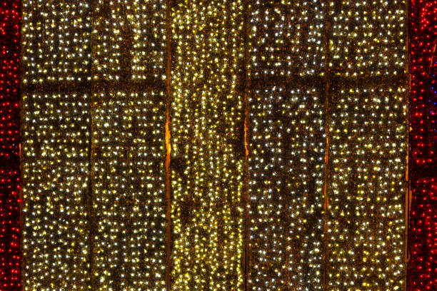 Twinkling christmas lights background. Wall illuminated by Christmas lights