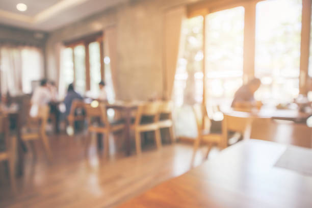 istock Restaurant interior with customer and wood table blur abstract background with bokeh light 1077401178
