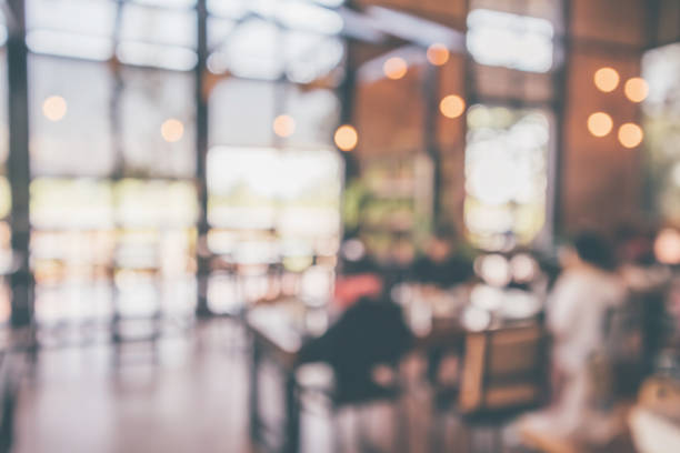 istock Restaurant cafe or coffee shop interior with customer blur abstract vintage style bokeh light for montage product display background 1077401196