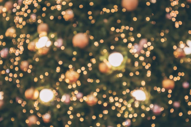 istock Abstract christmas holiday with festive gold bokeh light on tree blurred background 1077401646