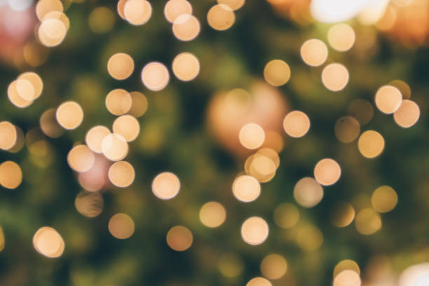 istock Abstract christmas holiday with festive gold bokeh light on tree blurred background 1077401650