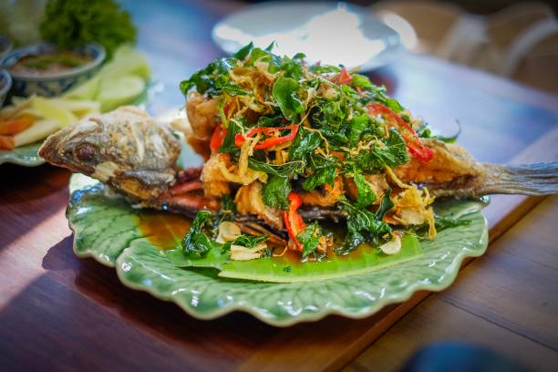 istock Fish fried with herbs healthy Thai foods 1077406290