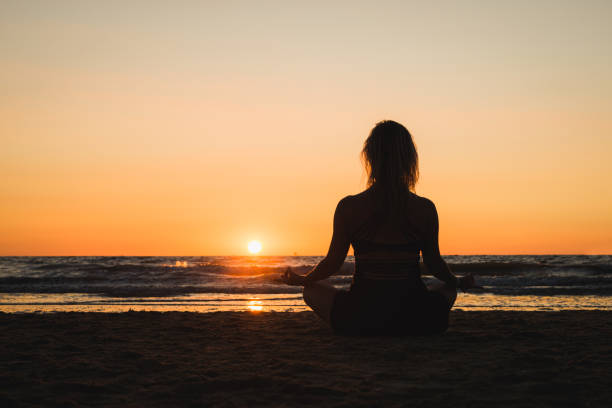 istock Silhouette of a girl practicing yoga 1077409014