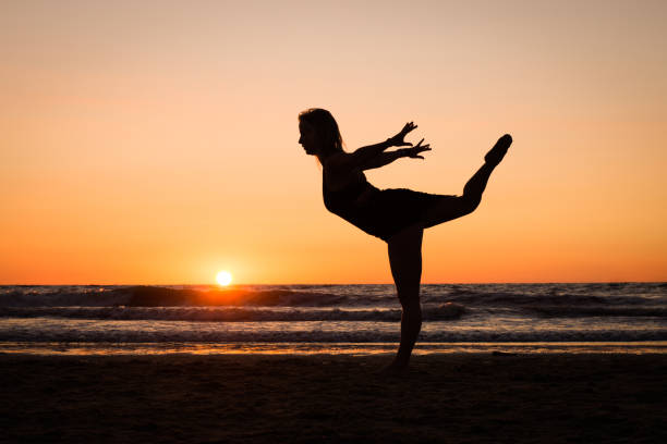 istock Silhouette of a girl practicing yoga 1077409030
