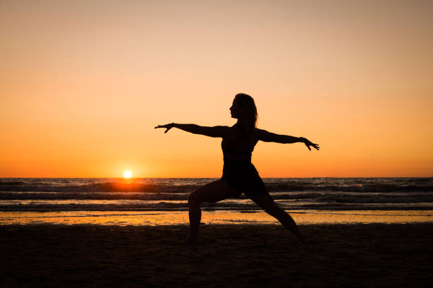 istock Silhouette of a girl practicing yoga 1077409032