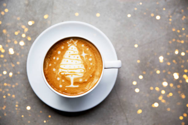 istock Tasty cappuccino with Christmas tree latte art with some blurred lights. 1077409140