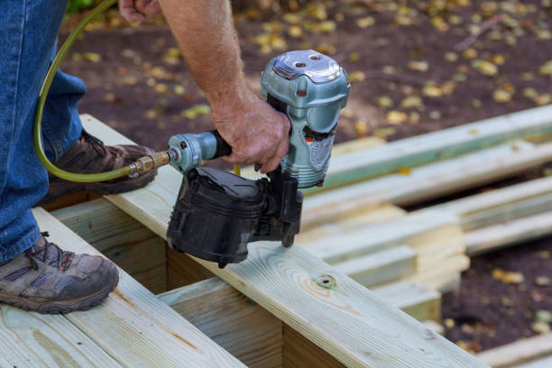 istock Worker installing wood floor for patio 1077428694