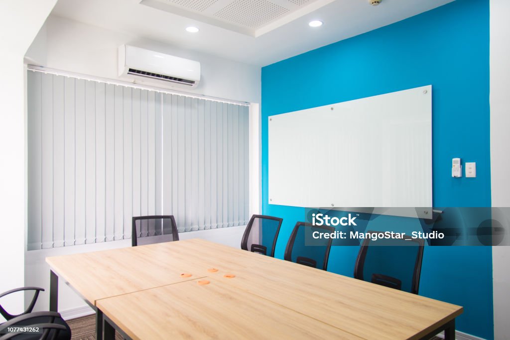 Small Conference Room With Whiteboard On Blue Wall Stock Photo
