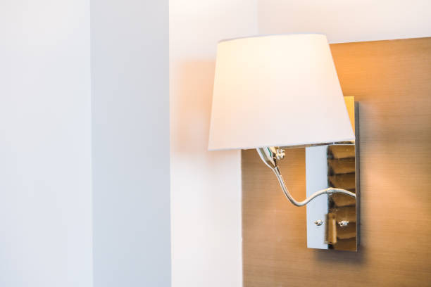 istock Close-Up Of Illuminated Electric Lamp On Wall 1077437152
