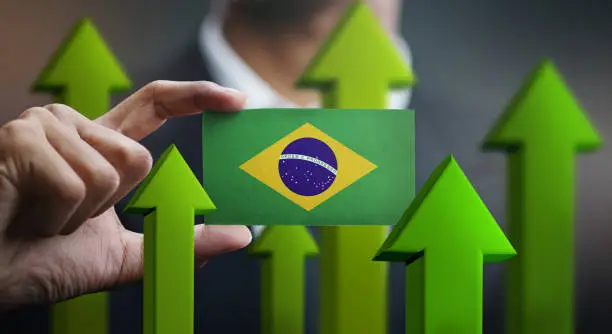 Nation Growth Concept, Green Up Arrows - Businessman Holding Card of Brazil Flag
